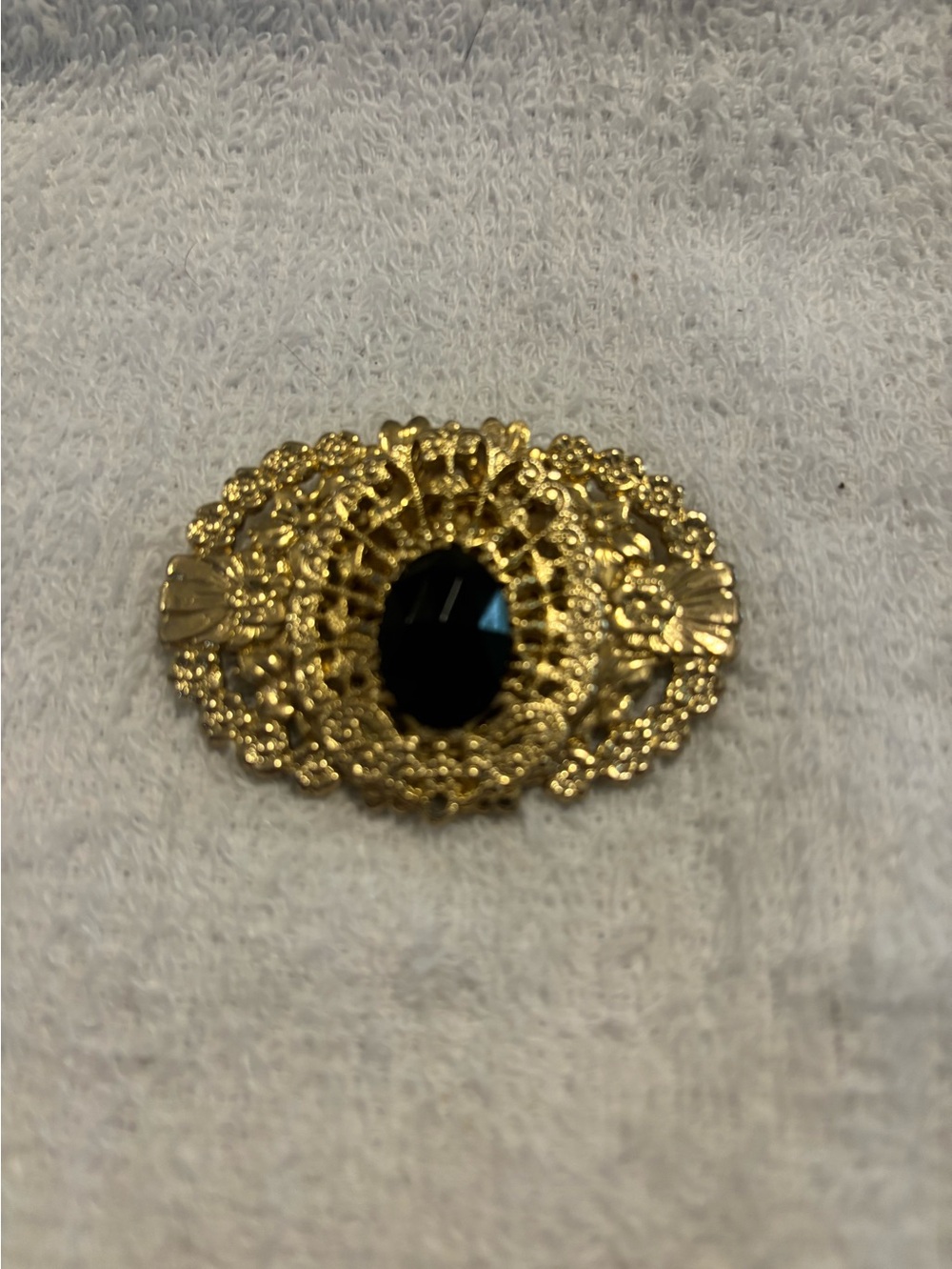 Ornate Gold tone filigree black cabochon brooch
